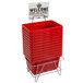 A stack of red plastic shopping baskets with a stand and sign.