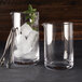 Two American Metalcraft clear cocktail stirring glasses with ice and mint leaves.