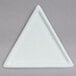 A white triangle shaped plate with a white triangle.