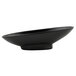 A black oval metal bowl with a textured finish.