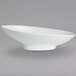 A white bowl with a curved bottom on a gray surface.