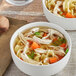 Two bowls of Hanover chicken noodle soup with noodles and vegetables.