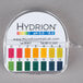 A Hydrion pH test paper dispenser label on a container of water.