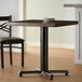 A Lancaster Table & Seating black cast iron table base with FLAT Tech levelers.