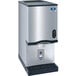 A silver and black Manitowoc countertop nugget ice maker and dispenser.