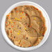 A white plastic container of David's Cookies Peanut Butter Edible Cookie Dough with Reese's Mini Pieces on a counter.