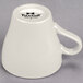 A white Tuxton china cappuccino mug with a handle.