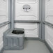 A white wheelchair accessible portable restroom with a toilet seat.