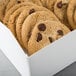 A white auto-popup bakery box filled with chocolate chip cookies.