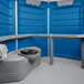 A blue and white PolyJohn wheelchair accessible portable toilet with a lid.