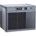 A grey rectangular metal Follett Horizon Elite water cooled ice machine with a vent.