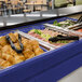 A navy blue Cambro buffet with food on it.