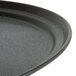 A black Carlisle oval non-skid tray with a flat bottom.