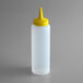 A white plastic bottle with a yellow cap.