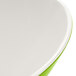 A white melamine bowl with a green interior and white rim.