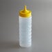 A clear plastic Vollrath squeeze bottle with a yellow cap.