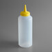 A white plastic bottle with a yellow lid.
