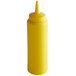 A yellow plastic Vollrath Traex squeeze bottle with a cone tip.