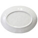 An Elite Global Solutions taupe melamine oval plate with a circular design on the edge.