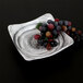 A black square melamine bowl with grapes on it.