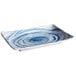 A white rectangular melamine plate with blue and white swirls.