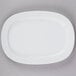 A CAC Super White rectangular porcelain platter with a white rim on a gray surface.