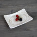 An Elite Global Solutions rectangular taupe melamine plate with berries on it.