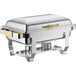 An Acopa Supreme stainless steel chafer with gold accents on a table.