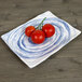 An Elite Global Solutions rectangular melamine plate with tomatoes on it.