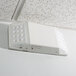 A white rectangular Lavex emergency light with two LED lights on the ceiling.