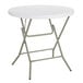 A Lancaster Table & Seating white round plastic folding table with a metal frame.