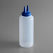 A white plastic bottle with a blue Twin Tip&#8482; lid.