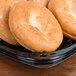 A bagel on a Sabert square catering tray with a high dome lid.