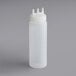 A clear plastic Vollrath Tri Tip wide mouth squeeze bottle with a white lid.