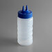 A Vollrath Traex clear plastic squeeze bottle with a blue Twin Tip lid.