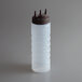 A clear plastic Vollrath Tri Tip squeeze bottle with a brown cap.