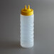 A clear Vollrath plastic squeeze bottle with a yellow Twin Tip lid.