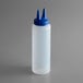 A white plastic Twin Tip squeeze bottle with a blue lid.
