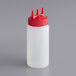 A Vollrath Tri Tip clear plastic squeeze bottle with a red plastic cap.