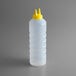 A clear plastic Vollrath squeeze bottle with a yellow cap.