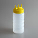 A close-up of a Vollrath plastic squeeze bottle with a yellow Tri Tip cap.