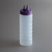A clear plastic Vollrath Twin Tip squeeze bottle with a purple cap with two pointy tops.