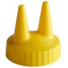 A close-up of a yellow Vollrath Twin Tip bottle cap with two pointy tops.