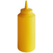 A close-up of a yellow Vollrath Traex squeeze bottle with a small tip.