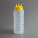 A clear plastic Vollrath Tri Tip squeeze bottle with a yellow cap.