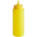 A yellow Vollrath Traex squeeze bottle with a pointy top.