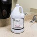A white bottle of Noble Chemical Pearl Ready-to-Use Lotion Hand Soap on a counter.
