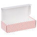 A white Valentine's Day candy box with red and white polka dots and an open lid.