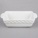 A white rectangular ceramic casserole dish with handles and a black border.