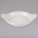 A white Hall China au gratin dish with two handles.